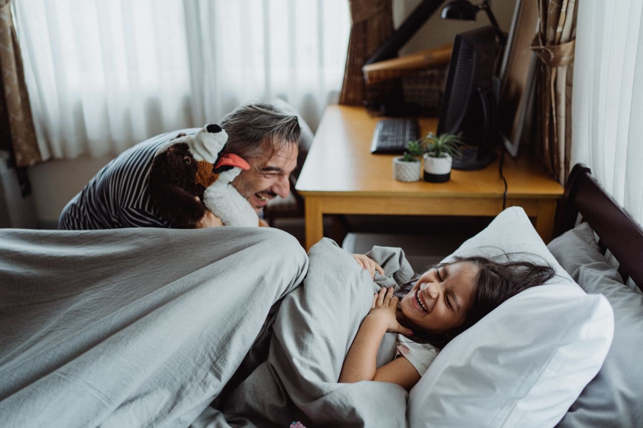 A parent and child compare bedtime story app options together.
